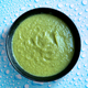 Cucumber Ketchup in black dish against background of water droplets